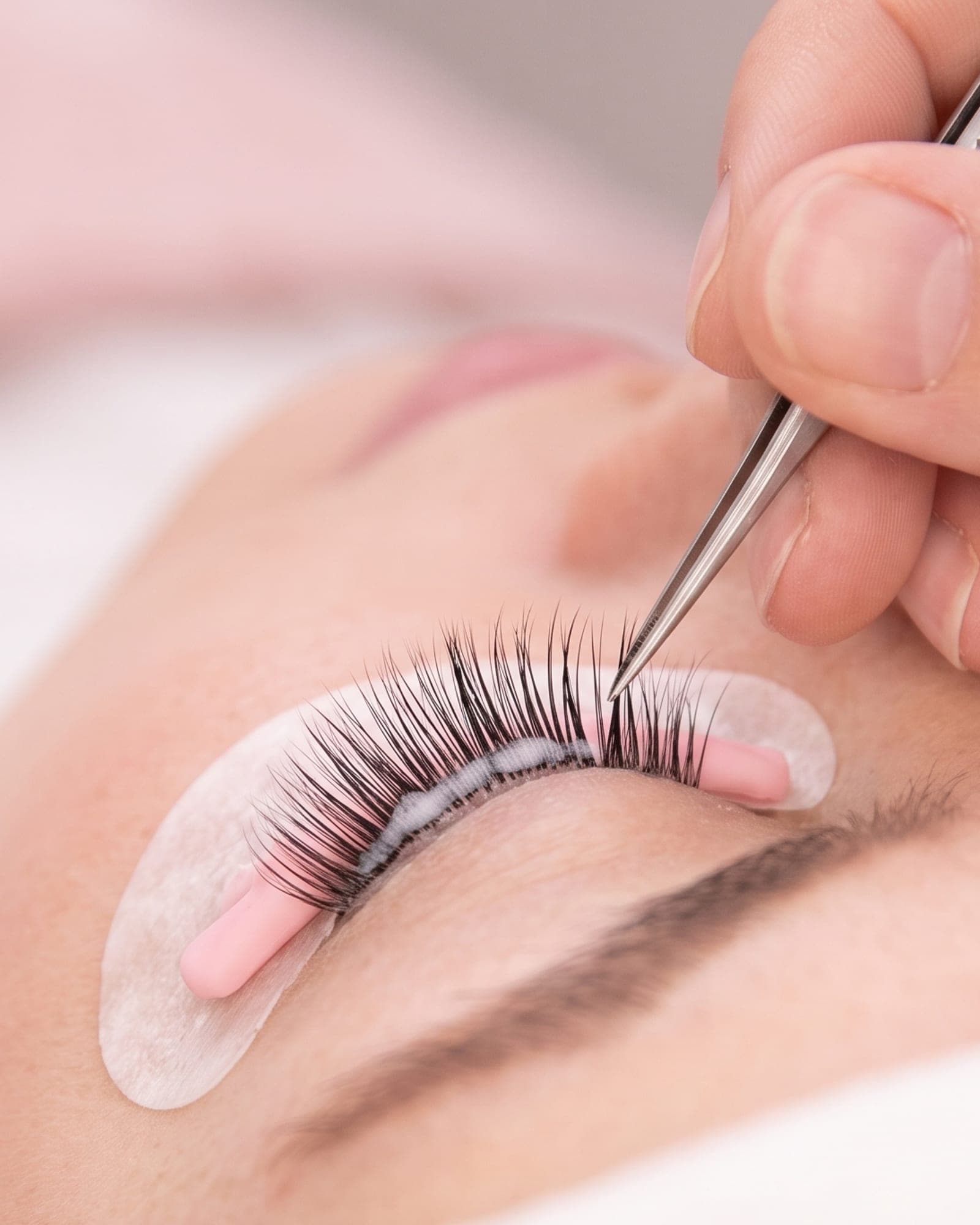 Close-up of a Lash Lift treatment with tweezers shaping and lifting the lashes at The Spa on Phillips