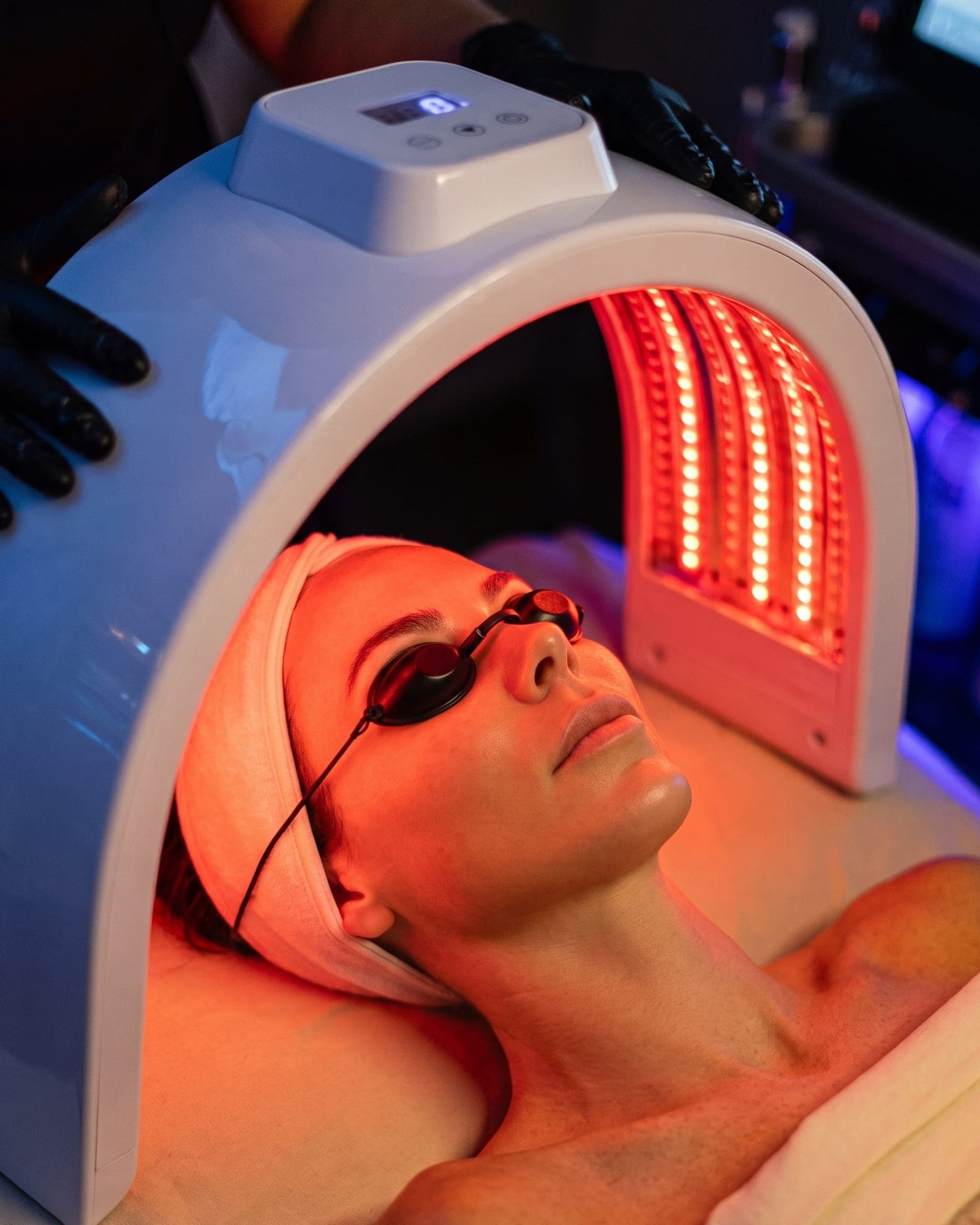 Guest receiving Red Light Mask Therapy with an LED facial mask at The Spa on Phillips